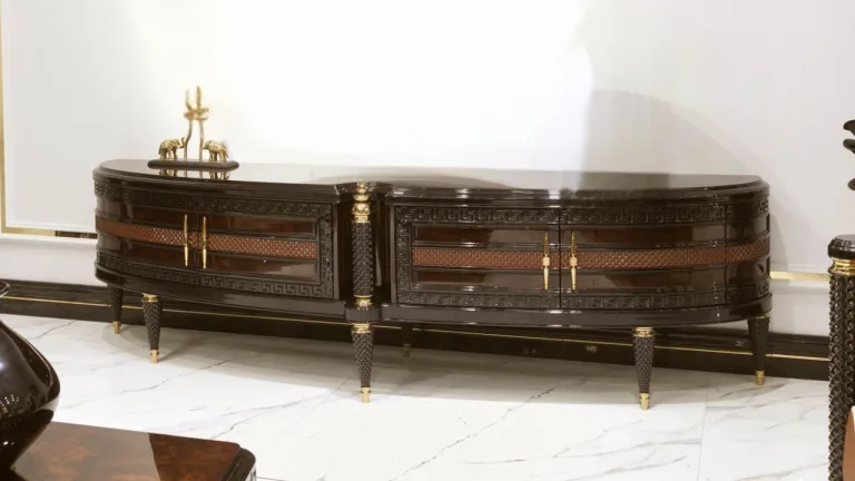 Valentino Ret TV stand: glossy dark console with carved detailing, rounded ends and gold-capped legs