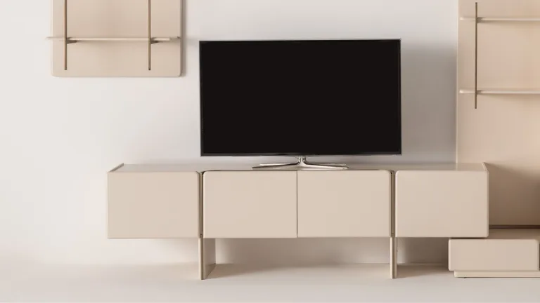 Soft TV stand: simple cream console with rounded edges and a low profile under a wall-mounted TV